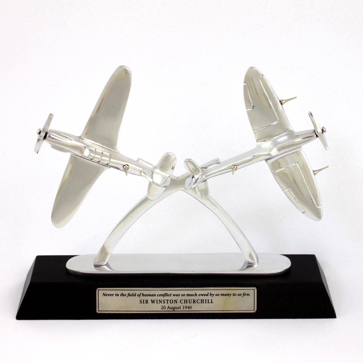 Aluminium model aircraft on a black base with the quote "Never in the field of human conflict was so much owed by so many to so few"