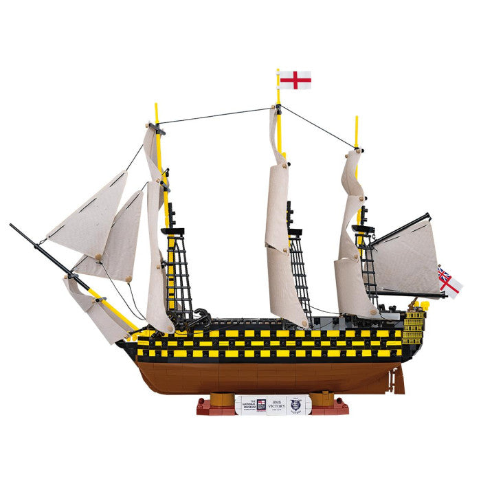 Model ship with multiple masts and sails on a white background