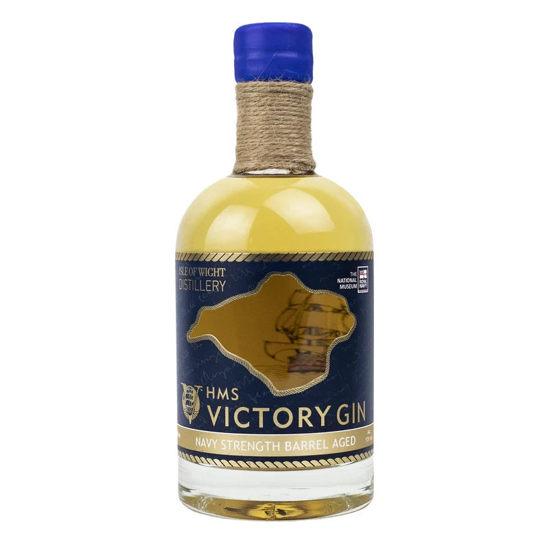 Bottle of HMS Victory Gin with blue cap and label on a white background