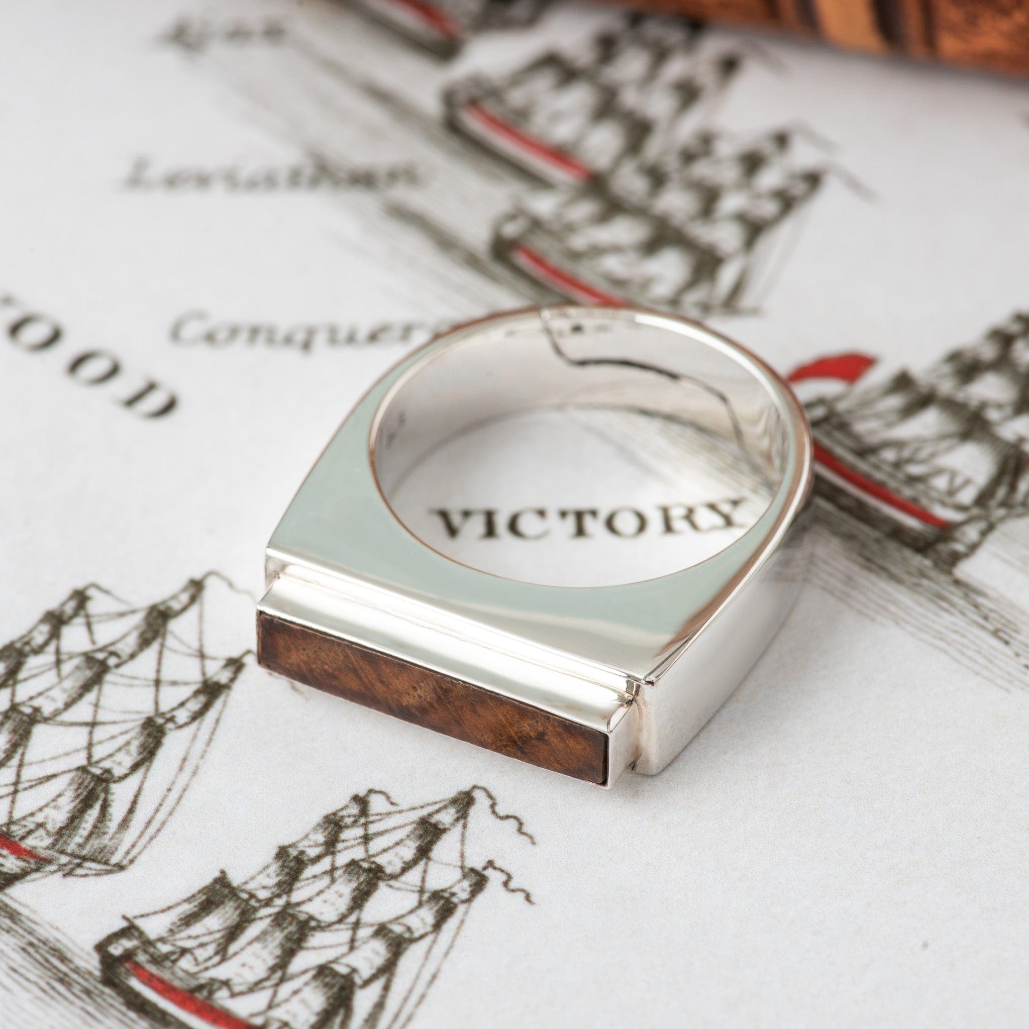 A ring containing a rectangular piece of original HMS Victory oak, set in sterling silver