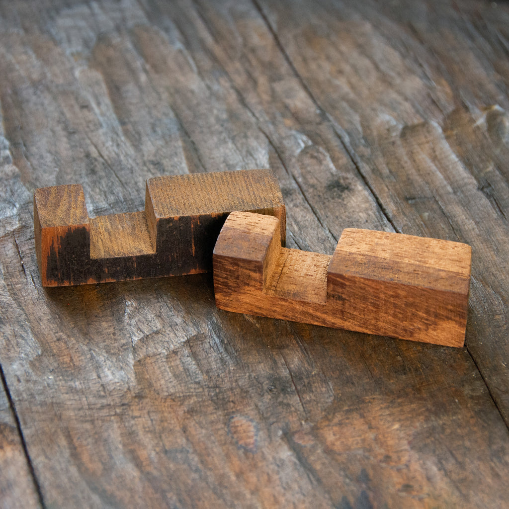 A wooden block with a notch in it.