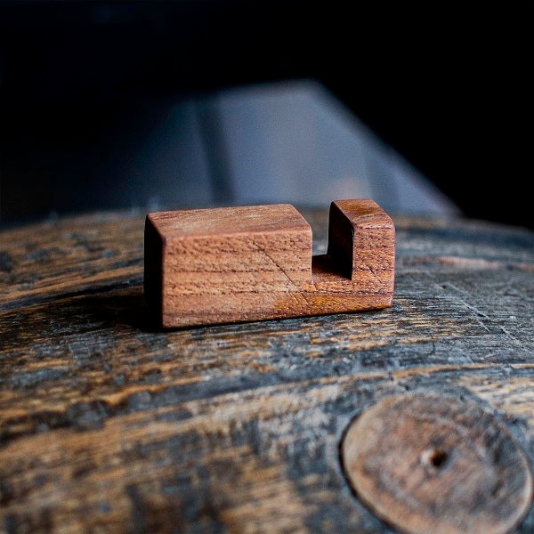 Wooden block on a rustic wooden surface with a dark background