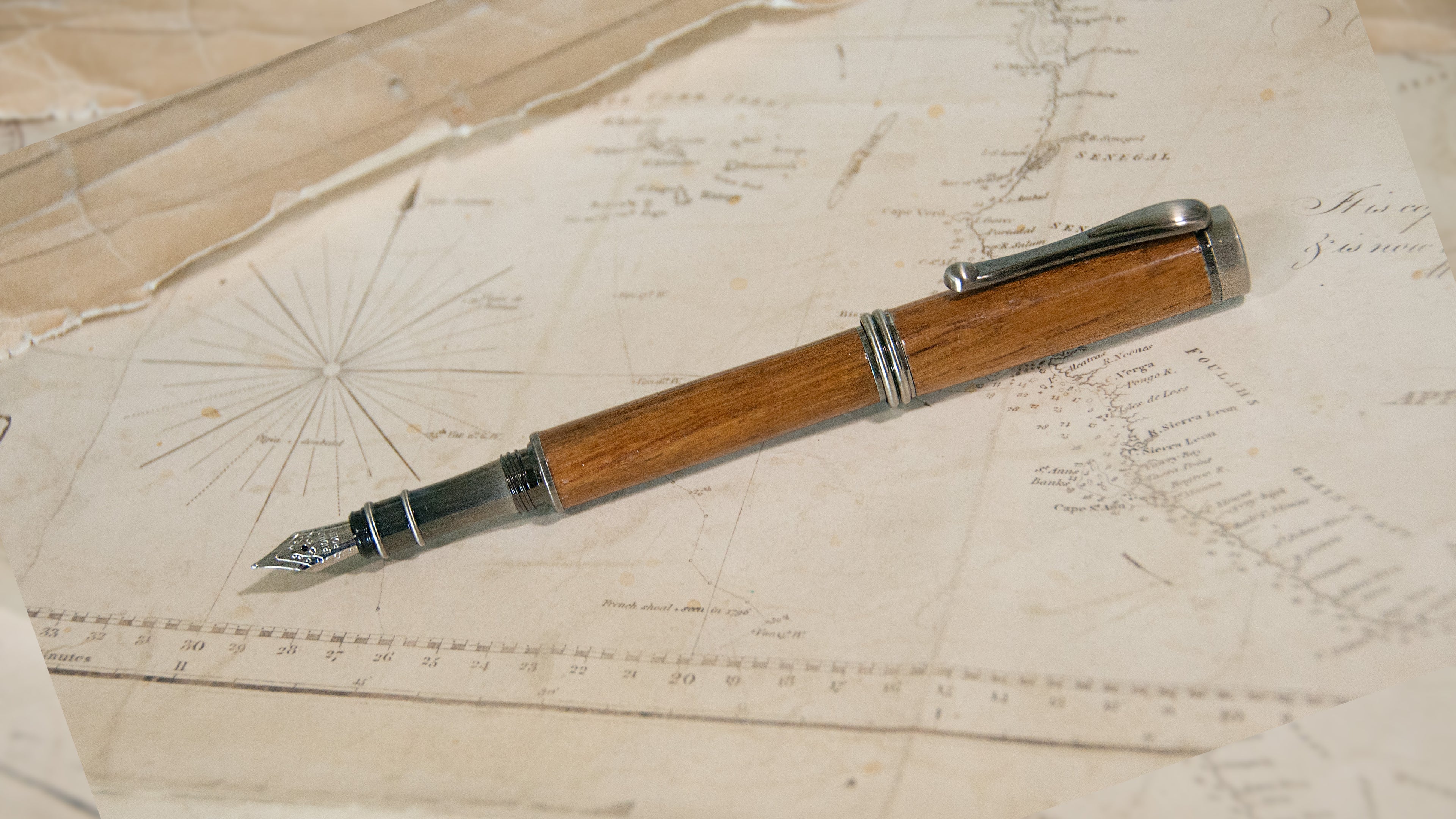 a wooden fountain pen with an antique brass tip