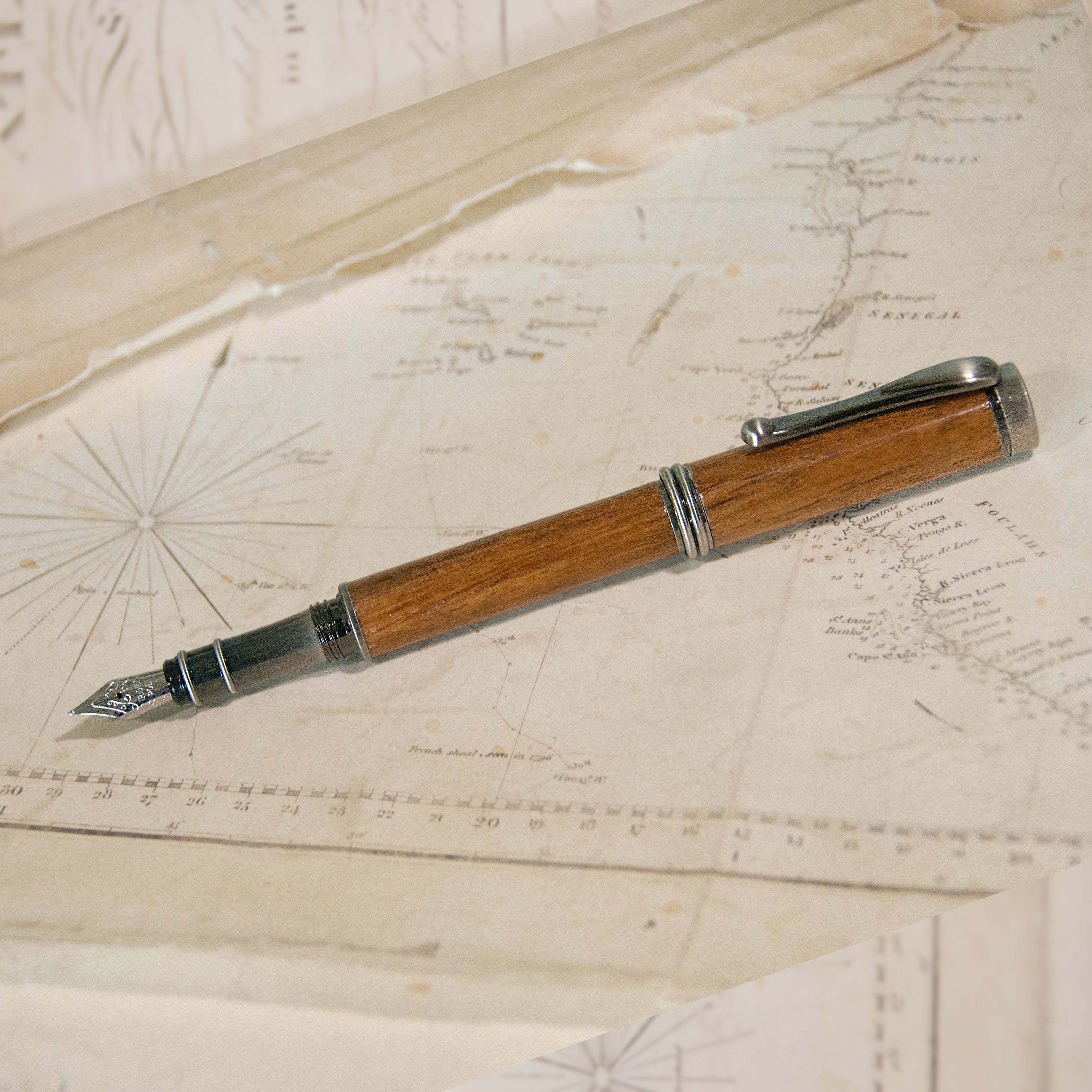 a wooden fountain pen with an antique brass tip