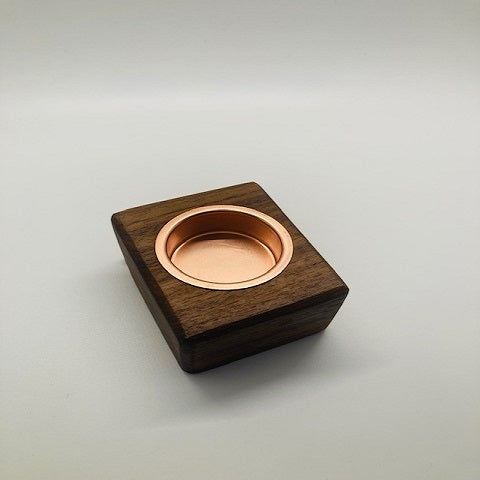 Wooden box with a copper interior on a light gray background