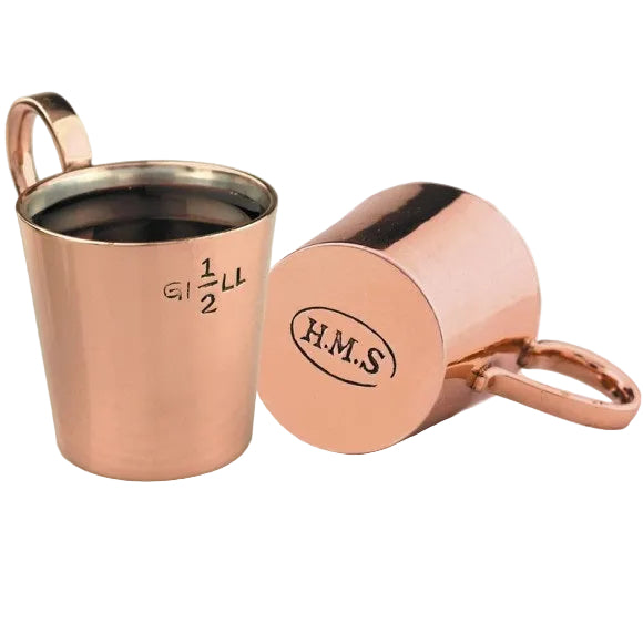 Copper measuring cup with handle and lid on a white background