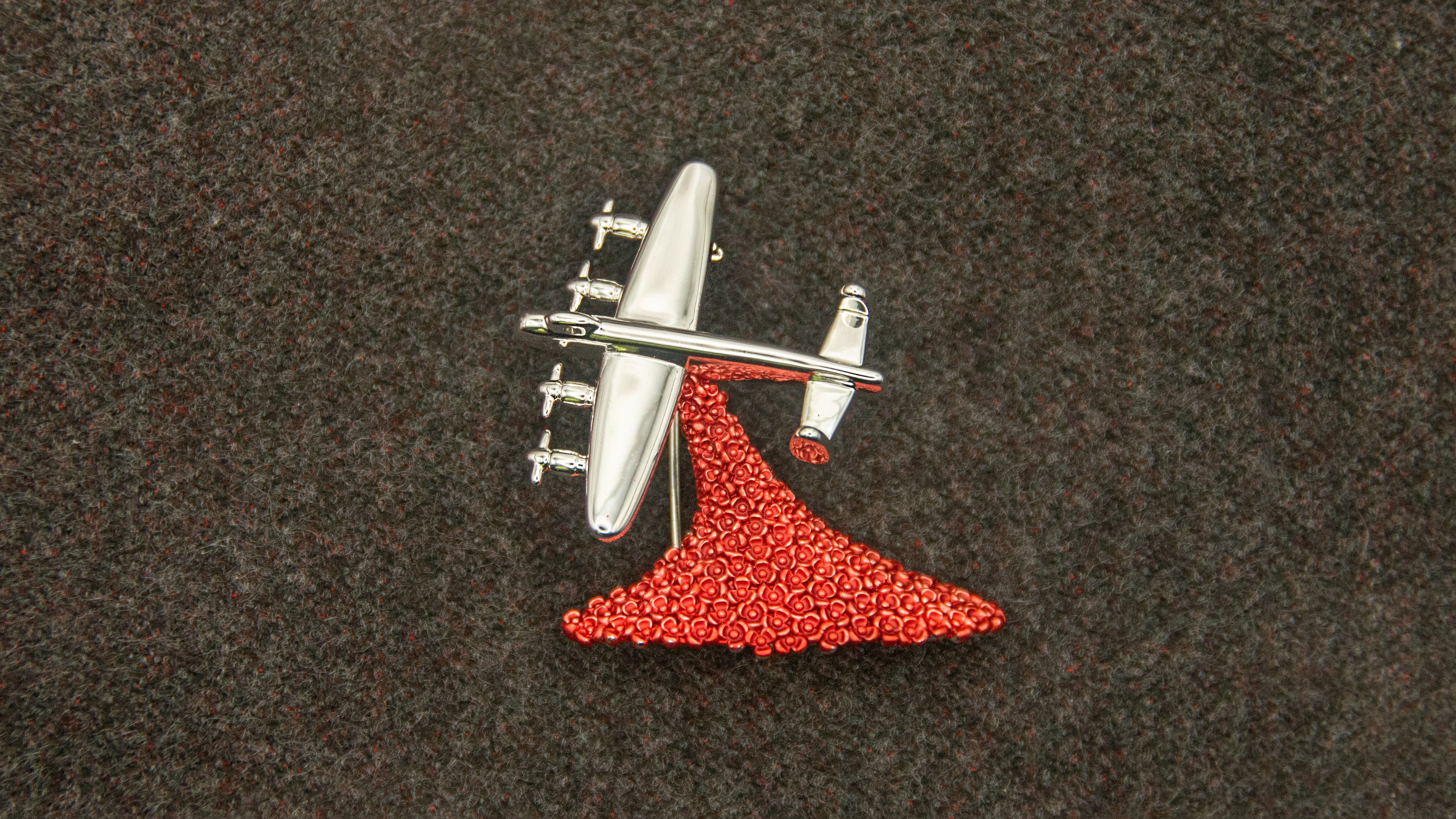 A Metallic Lancaster Bomber performing a “Drop” of cascading red poppies