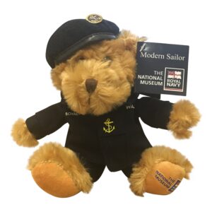 Teddy bear dressed as a sailor with a tag on a white background