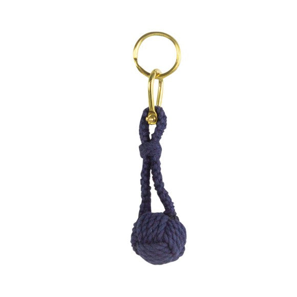 Navy blue rope monkey's fist keychain with gold metal ring on a white background