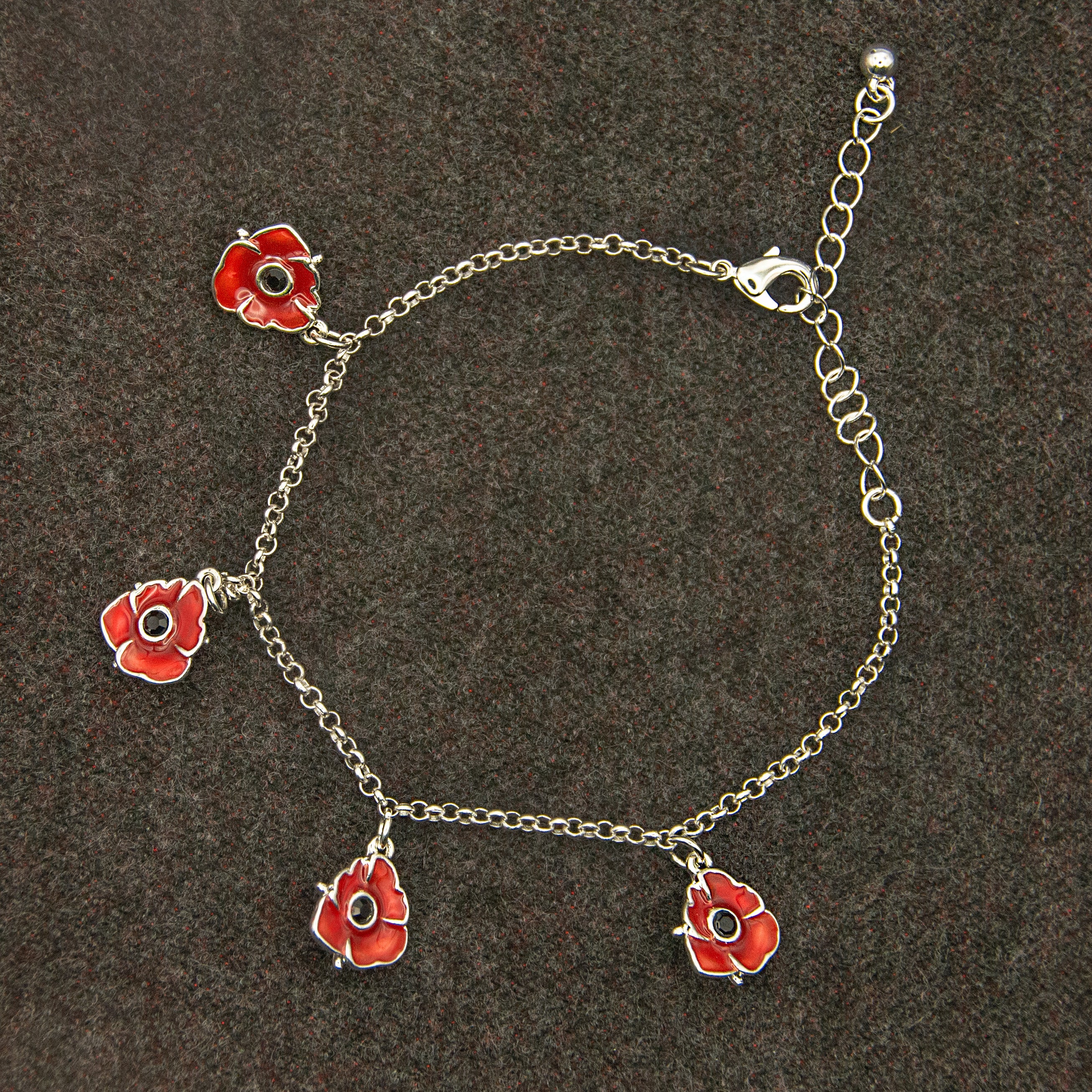 Bracelet with four red poppy charms.