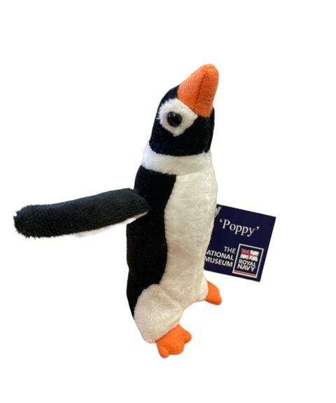 Plush penguin toy with a tag on a white background
