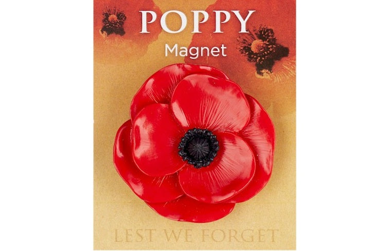 Red poppy magnet with 'Lest We Forget' text on a gold background