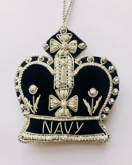 Decorative emblem with embroidered details on a white background