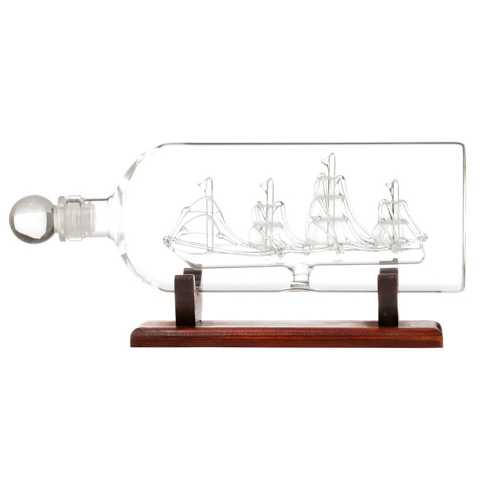 Model ship inside a bottle on a wooden base with a white background