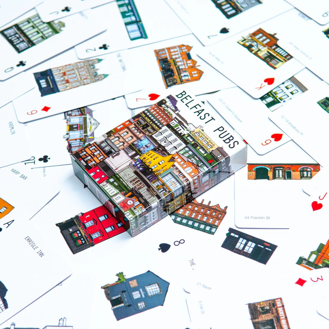 Card game box titled 'Belfast Pubs' surrounded by playing card-style illustrations of buildings on a white background.