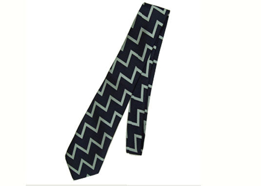 Navy blue tie with light green zigzag pattern on a white background